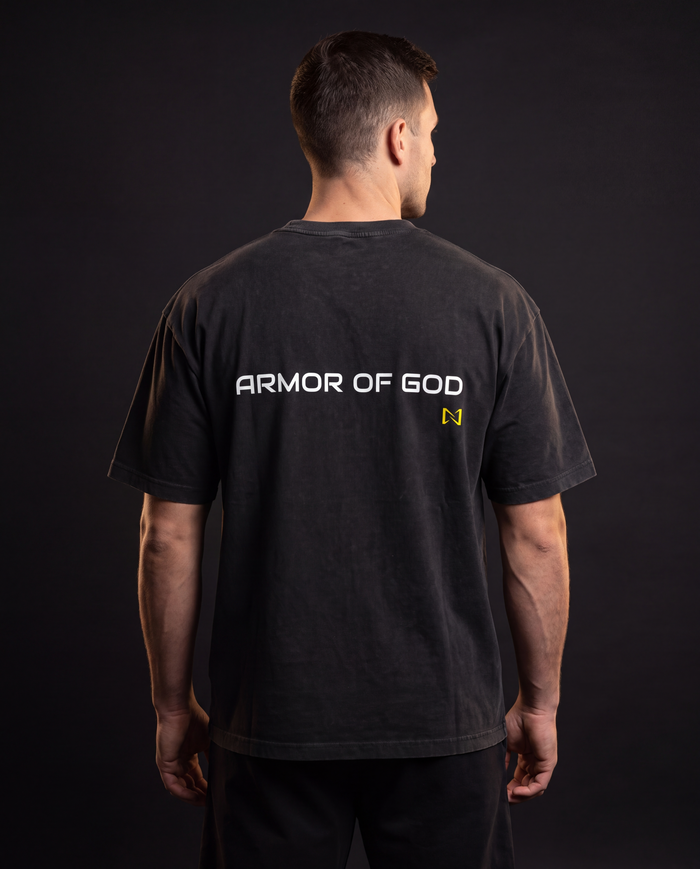 Model wearing the NPRWLR Vintage Wash Boxy T-Shirt in black, back view showing the ARMOR OF GOD print across the upper back