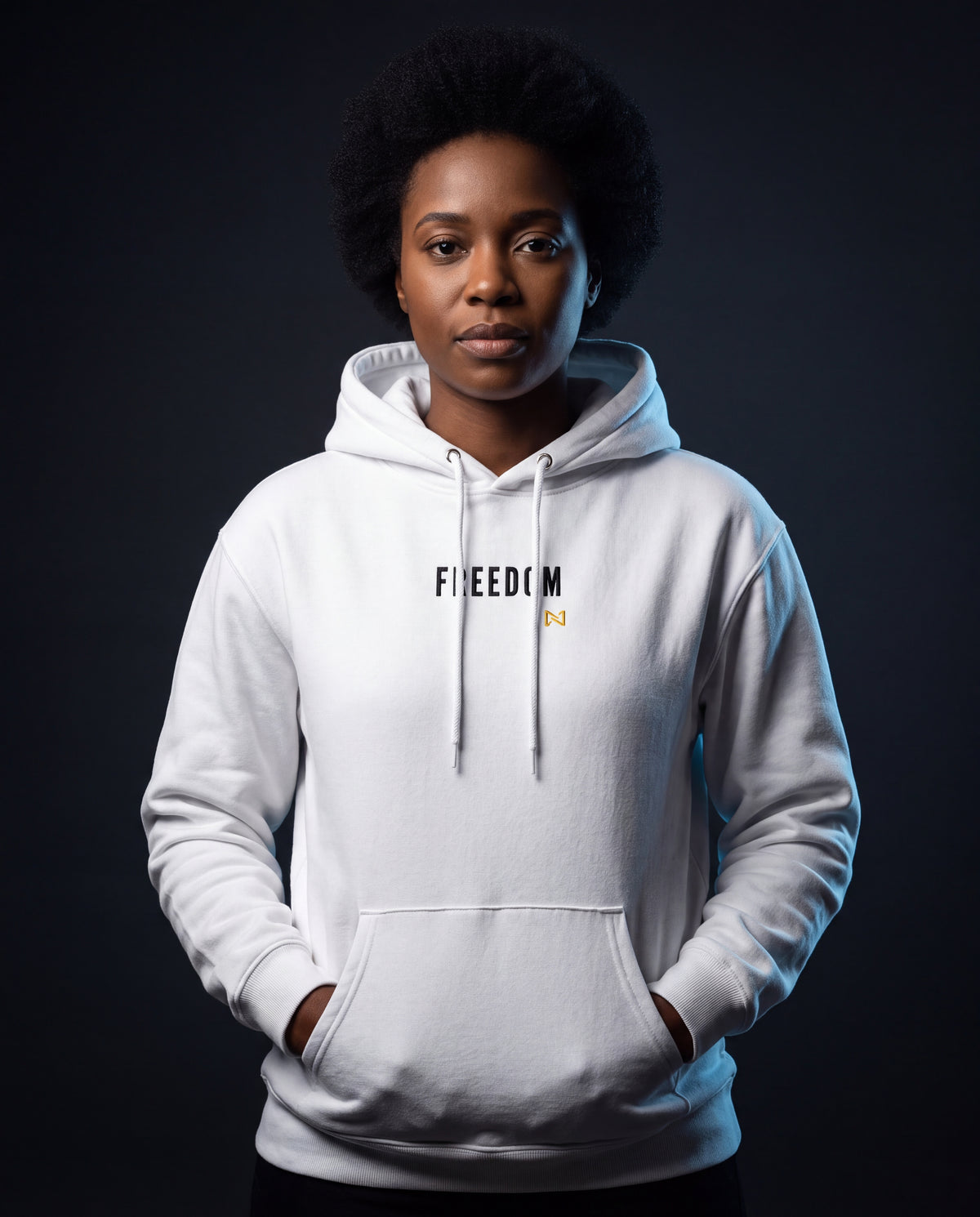 Model wearing the NPRWLR Freedom Unisex Fleece Hoodie in white, front view with the embroidered FREEDOM chest wordmark