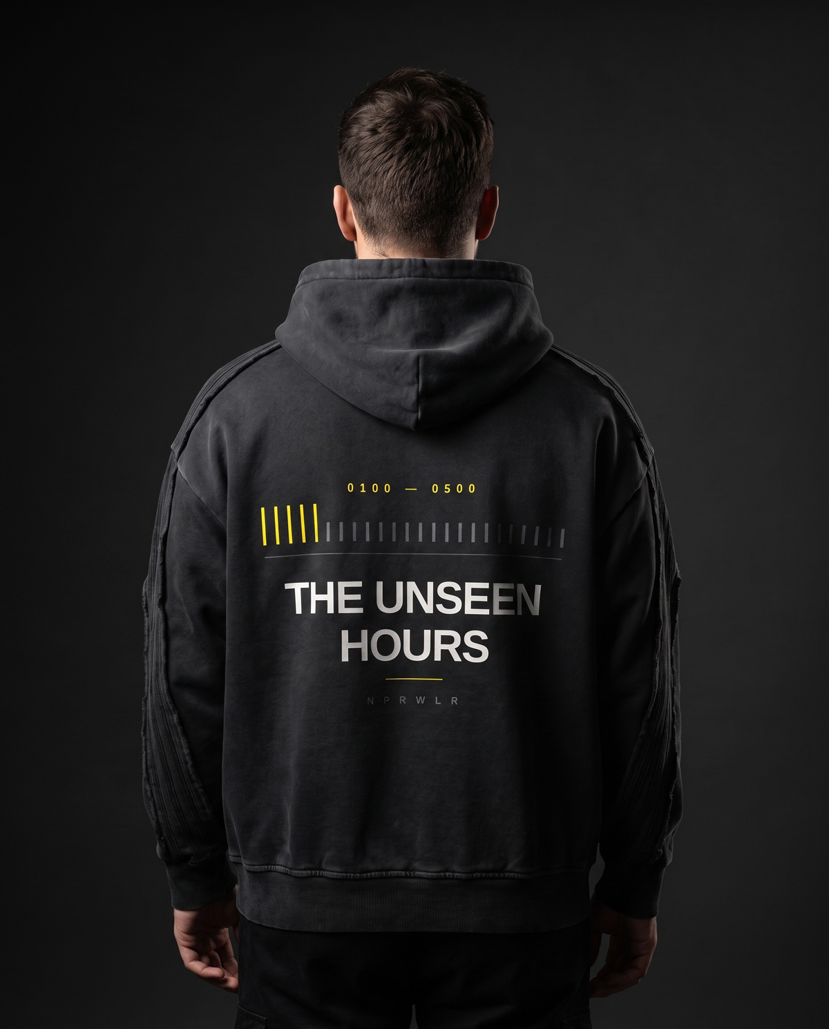 Model wearing the NPRWLR Snow Wash Hoodie in black, back view showing the centre-back print, 420gsm washed cotton