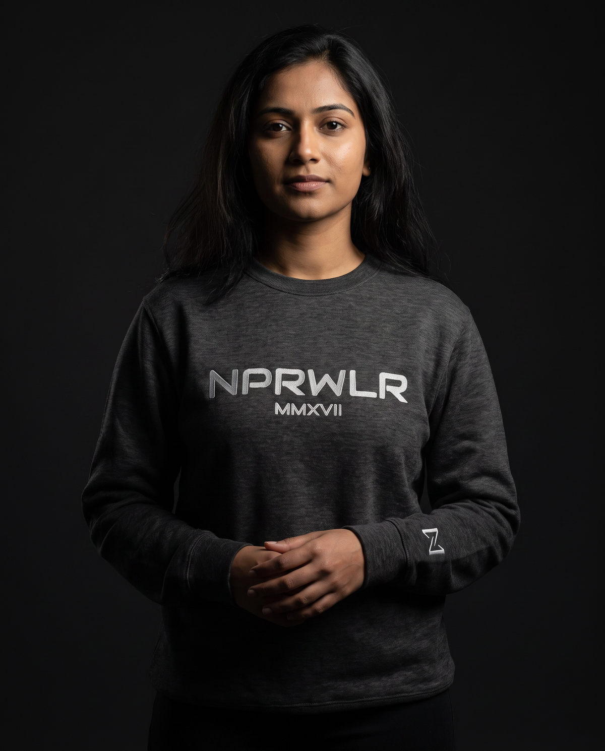 Model wearing the NPRWLR Night Shift Premium Sweatshirt in charcoal heather, front view with the chest wordmark