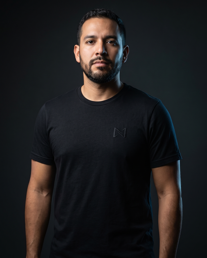 Model wearing the NPRWLR Logo T-Shirt in black, front view showing the small embroidered left-chest mark