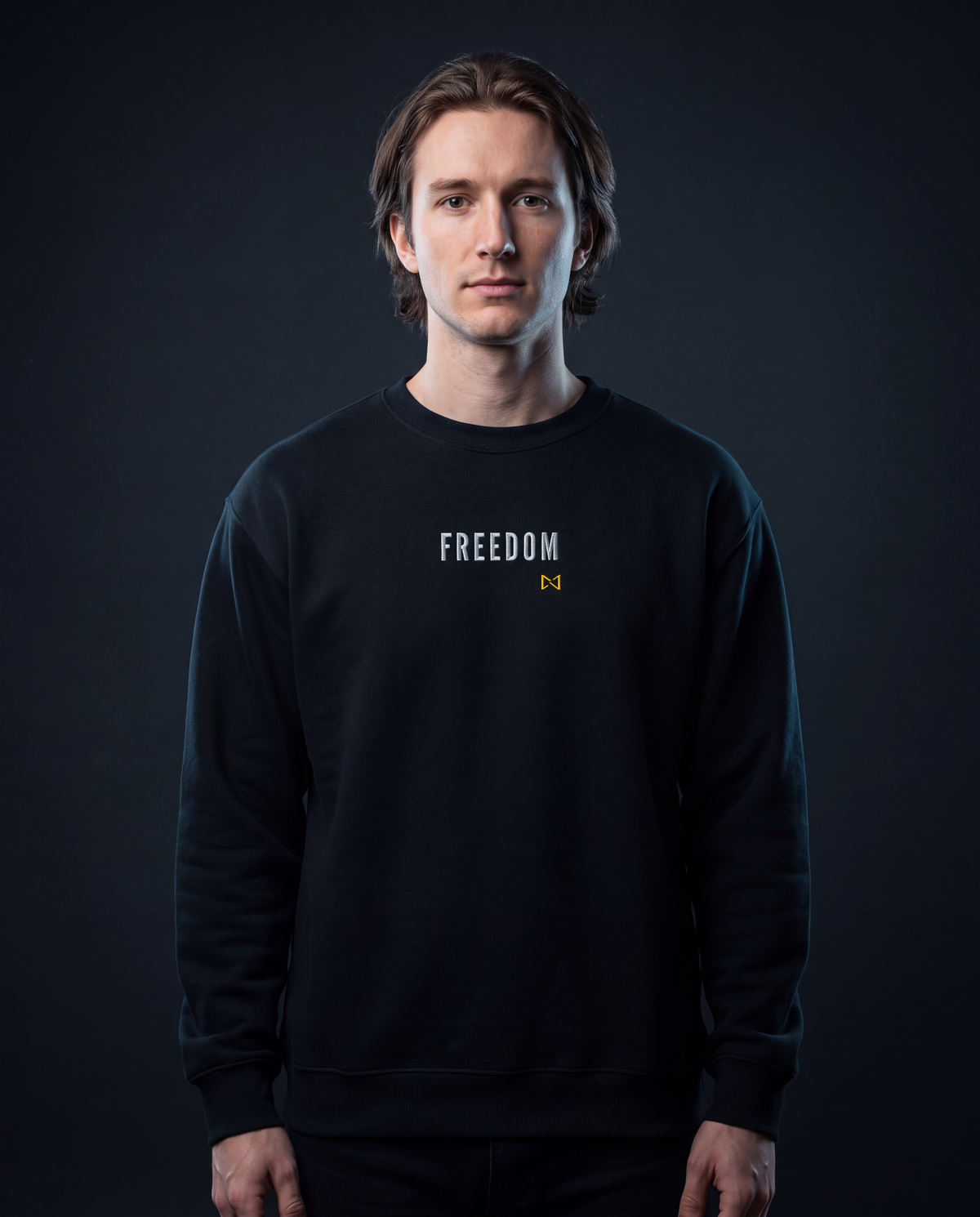 Model wearing the NPRWLR Freedom Unisex Fleece Sweatshirt in black, front view with the embroidered FREEDOM chest wordmark